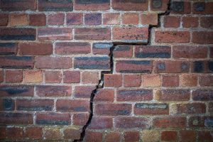 cracked red brick wall